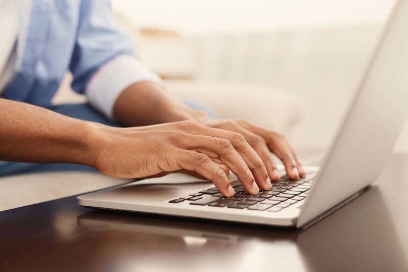 Person Typing at Computer